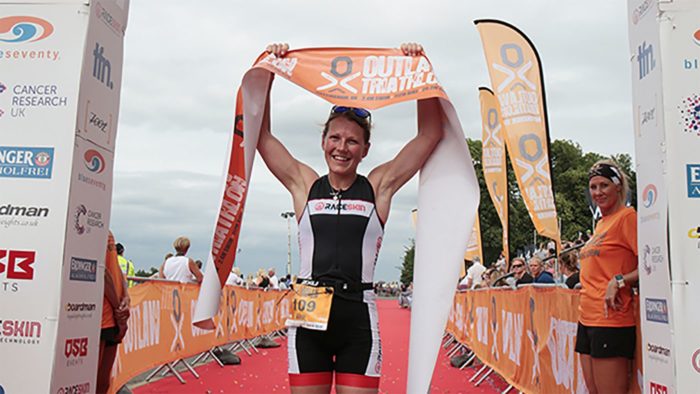 Ali Wilson crossing the line at Outlaw Triathlon