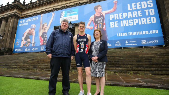 Jonny Brownlee poses in front of Leeds Town Hall ahead of the Columbia Threadneedle World Triathlon Leeds with Wayne Coyle (event director) and Leeds councillor Judith Blake.on 10 & 11 June 2017. Barrington Coombs/PA Wire