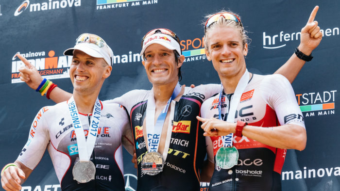 FRANKFURT AM MAIN, GERMANY - JULY 09: (EDITORS NOTE: This image was altered using a digital filter) second place Andi Boecherer, first place Sebastian Kienle and third place Patrik Nilsson celebrate during the Ironman European Championships on July 9, 2017 in Frankfurt am Main, Germany. (Photo by Alexander Scheuber/Getty Images for Ironman)