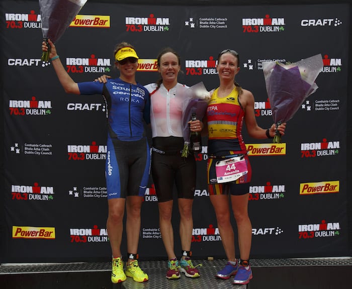 DUBLIN, IRELAND - AUGUST 20: Athlete Sarah Lewis from Great Britain celebrates winning the women race of IRONMAN 70.3 Dublin with Sussie Chetham from Great Britain (L) second and Amanda Wilson from Australia (R) third at the finish line on August 20, 2017 in Dublin, Ireland. (Photo by Pablo Blazquez Dominguez/Getty Images for IRONMAN)