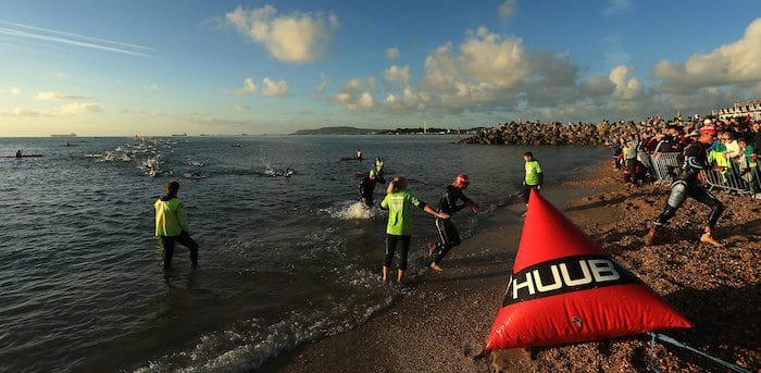 WEYMOUTH, ENGLAND - SEPTEMBER 11: Athletes exit the water on the swim course during Ironman Weymouth on September 11, 2016 in Weymouth, England. (Photo by Stephen Pond/Getty Images)