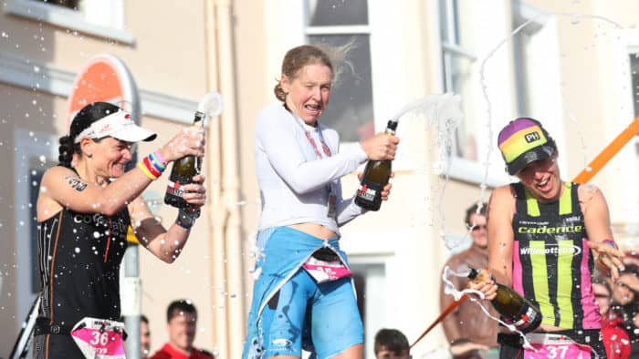 TENBY, WALES - SEPTEMBER 10: Lucy Gossard of Great Britain celebrates on the podium after she finishes first in the Women's race during the Ironman Wales competiton on September 10, 2017 in Tenby, Wales. (Photo by Ian MacNicol/Getty Images for IRONMAN)