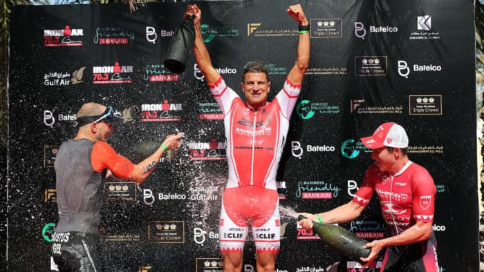 BAHRAIN, BAHRAIN - DECEMBER 10: Terenzo Bozzone (C) of New Zealand celebrates winning the Ironman 70.3 Middle East Championship Bahrain with Steffen Jutus (L) of Germany second and Sam Appleton of Australia third on December 10, 2016 in Bahrain, Bahrain. (Photo by Nigel Roddis/Getty Images for Ironman)