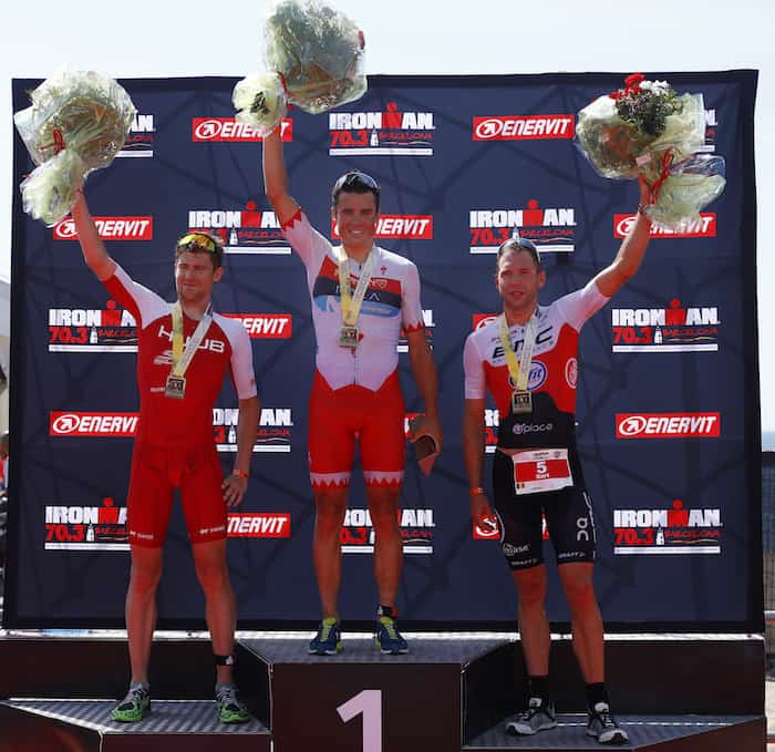 BARCELONA, SPAIN - MAY 20: Javier Gomez Noya, David McNamee and Bart Aermouts celebrate their placings during IRONMAN 70.3 Barcelona on May 20, 2018 in Barcelona, Spain. (Photo by Charlie Crowhurst/Getty Images for IRONMAN)