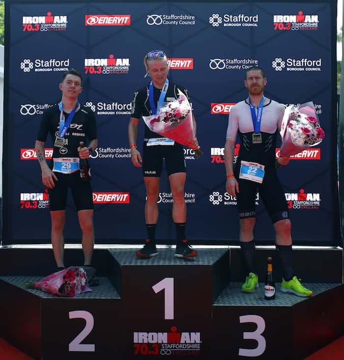 LICHFIELD, ENGLAND - JUNE 10: Elliot Smales of Great Britain celebrates as he wins the mens pro race with Bryan McCrystal and George Goodwin during the IRONMAN 70.3 Staffordshire on June 10, 2018 in Lichfield, England. (Photo by Charlie Crowhurst/Getty Images for IRONMAN)