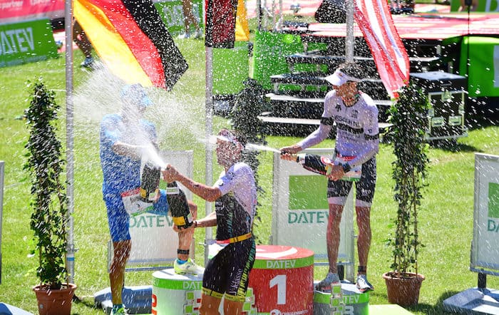 ROTH, GERMANY - JULY 01: Andreas Dreitz of Germany (2nd), Sebastian Kienle (1st) of Germany and Jesse Thomas (3rd) of the United States of America celebrates during the DATEV Challenge Roth 2018 on July 1, 2018 in Roth, Germany. (Photo by Alexander Koerner/Getty Images)