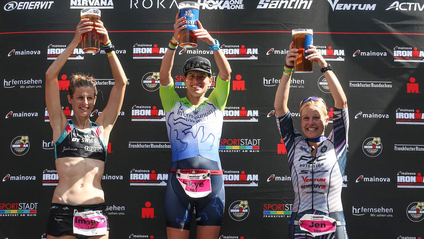 FRANKFURT AM MAIN, GERMANY - JUNE 30: Jen Annett of Canada, Skye Moench of USA and Imogen Simmonds of Switzerland celebrate on the podium after finishing the women's race of Mainova IRONMAN European Championship on June 30, 2019 in Frankfurt am Main, Germany. (Photo by Joern Pollex/Getty Images for IRONMAN)