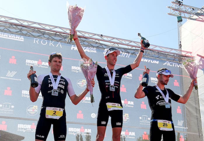 VICHY, FRANCE - AUGUST 24: Yohan Le Berre of France (C) David McNamee of Britain (L) and Franz Loeschke of Germany on the podium of Ironman 70.3 Vichy on August 24, 2019 in Vichy, France. (Photo by Nigel Roddis/Getty Images for IRONMAN)