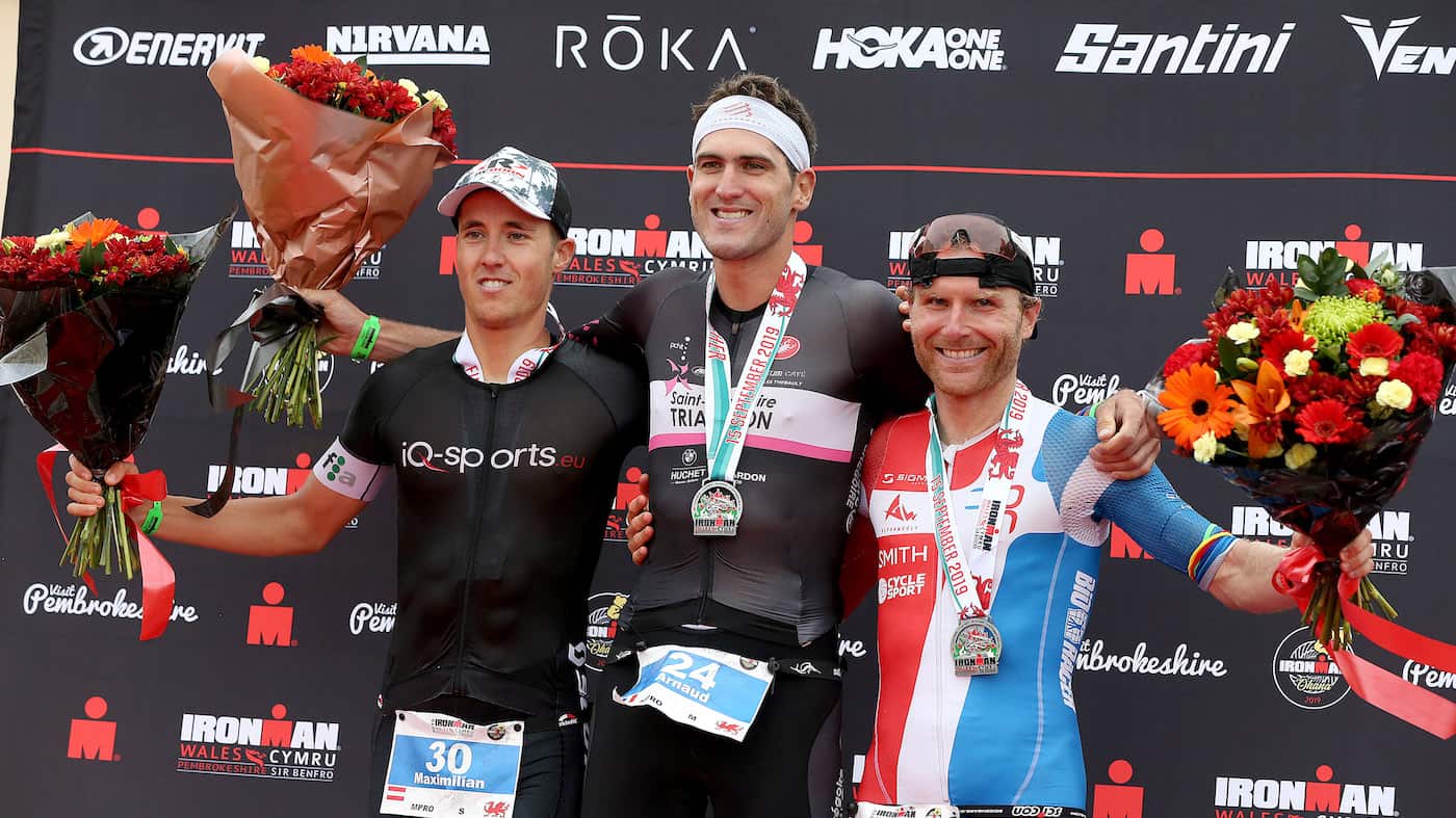 TENBY, WALES - SEPTEMBER 15: Amaud Guilloux of France (C), Maximillian Hammerle of Austria (L) and Fabian Rahn of Germany (R) on the podium of Ironman Wales on September 15, 2019 in Tenby, Wales. (Photo by Nigel Roddis/Getty Images for IRONMAN)