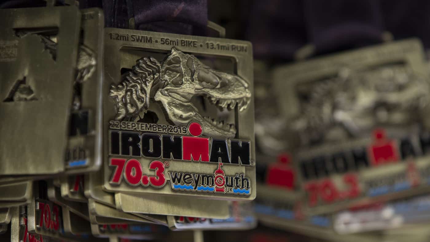 WEYMOUTH, ENGLAND - SEPTEMBER 22: Finisher medals hung from hook at the finish line of Ironman Weymouth 70.3 on September 22, 2019 in Weymouth, England. (Photo by Pablo Blazquez Dominguez/Getty Images for IRONMAN)