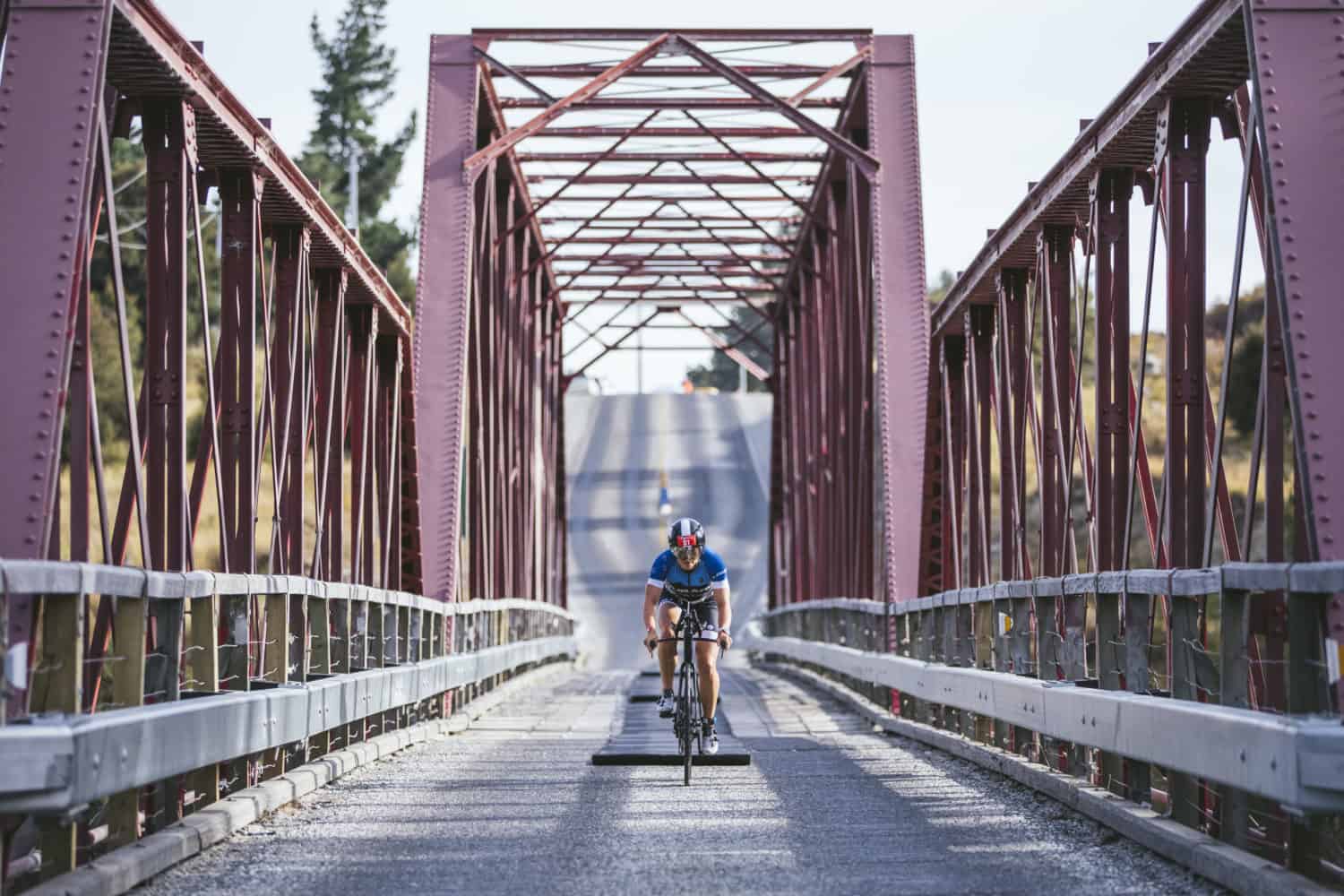 Hannah Wells crosses the famous 'Red Bridge' near Luggate, in the Integrity Homes Challenge Wanaka/Challenge Asia Pacific Championships 2020