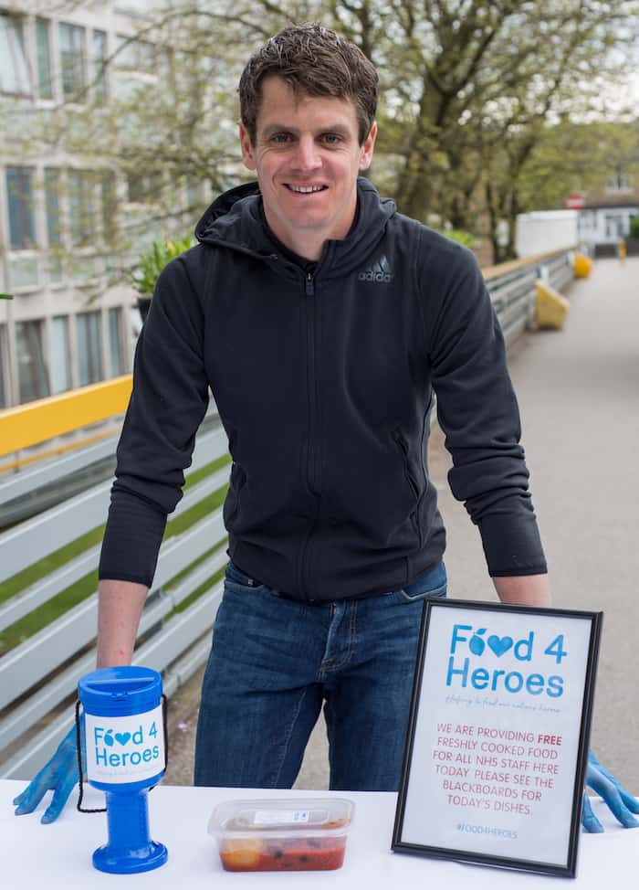 British triathlete Jonny Brownlee stood outside Huddersfield Royal Infirmary with the 100,000th meal for NHS staff made by charity Food4Heroes set up by Amanda Guest of Guest Dining during COVID-19 outbreak. They provide free meals to hospital staff to ensure that they have healthy food to eat on shift.