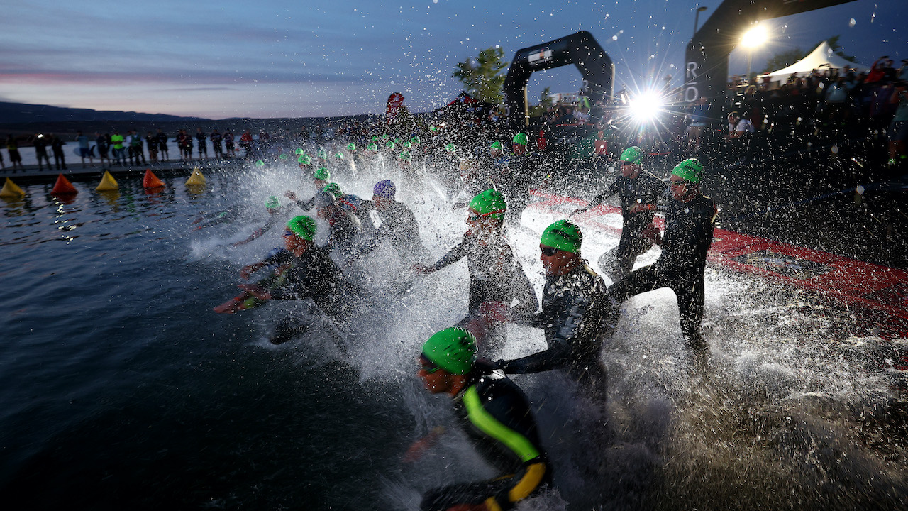 ST GEORGE, UTAH - MAY 07: Athletes make their way into the water for the men's pro swim start during the 2021 IRONMAN World Championships on May 07, 2022 in St George, Utah. (Photo by Tom Pennington/Getty Images for IRONMAN)