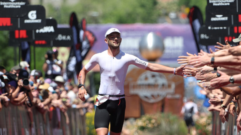 ST GEORGE, UTAH - MAY 07: Sam Laidlow of France high fives fans as he approaches the finish line of the 2021 IRONMAN World Championships on May 07, 2022 in St George, Utah. (Photo by Tom Pennington/Getty Images for IRONMAN)