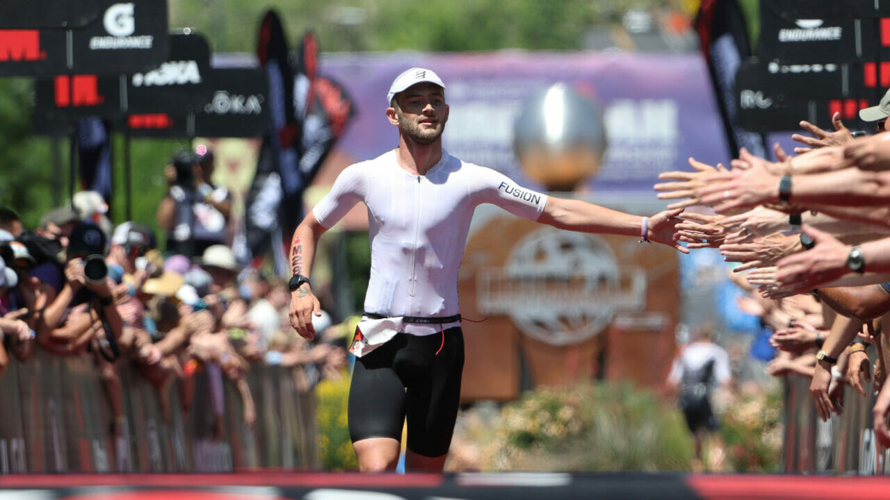 ST GEORGE, UTAH - MAY 07: Sam Laidlow of France high fives fans as he approaches the finish line of the 2021 IRONMAN World Championships on May 07, 2022 in St George, Utah. (Photo by Tom Pennington/Getty Images for IRONMAN)