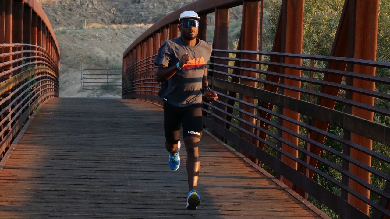 Sam Holness running over bridge