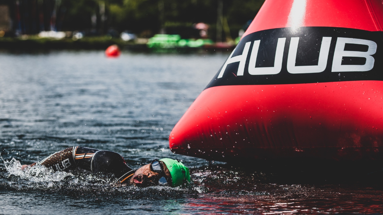 Sam Holness swimming around a buoy