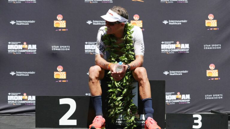 Third placed finisher Braden Currie sits on podium at St George photo credit IRONMAN