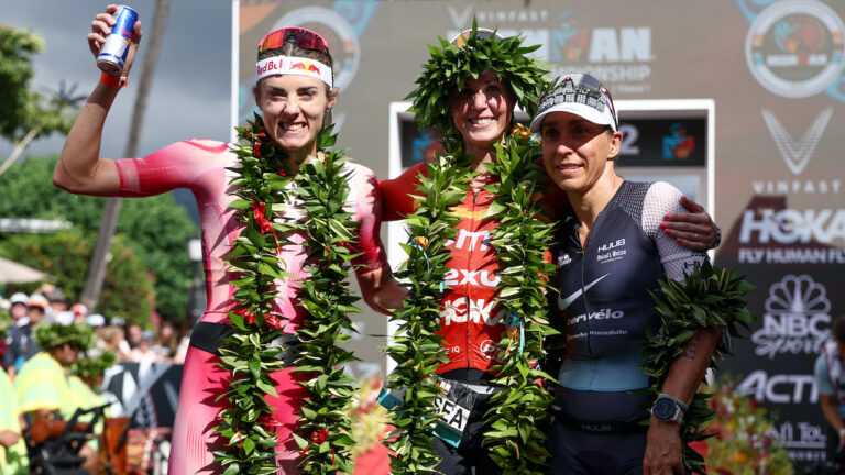 KAILUA KONA, HAWAII - OCTOBER 06: Lucy Charles-Barclay of Great Britain (2nd), Chelsea Sodaro (1st) and Anne Haug of Germany (3rd) celebrate after finishing the Ironman World Championships on October 06, 2022 in Kailua Kona, Hawaii. (Photo by Tom Pennington/Getty Images for IRONMAN)