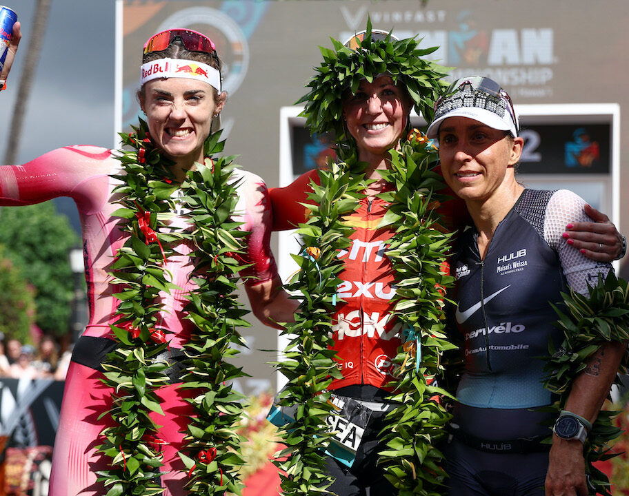 KAILUA KONA, HAWAII - OCTOBER 06: Lucy Charles-Barclay of Great Britain (2nd), Chelsea Sodaro (1st) and Anne Haug of Germany (3rd) celebrate after finishing the Ironman World Championships on October 06, 2022 in Kailua Kona, Hawaii. (Photo by Tom Pennington/Getty Images for IRONMAN)