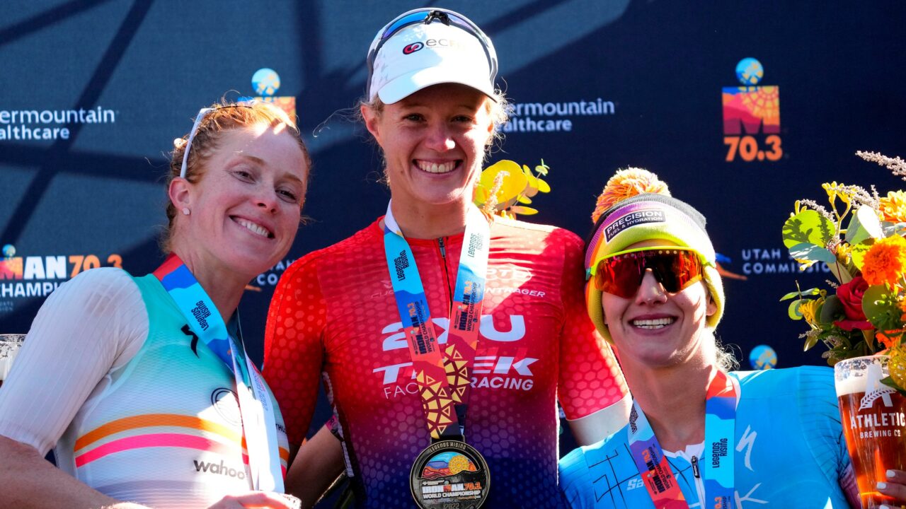 ST GEORGE, UTAH - OCTOBER 28: (L-R) Paula Findlay of Canada in second place, Taylor Knibb of the United States in first place, and Emma Pallant-Browne of Britain in third place celebrate on the podium after the IRONMAN 70.3 World Championship on October 28, 2022 in St George, Utah. (Photo by Patrick McDermott/Getty Images for IRONMAN)