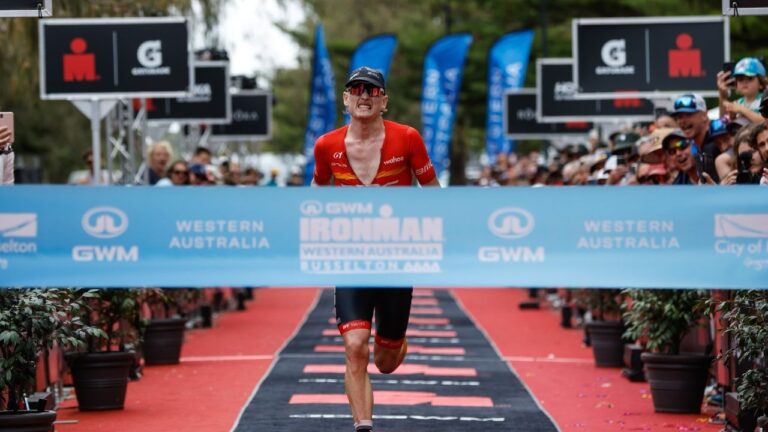 Max Neumann sprinting for the line at GWM IRONMAN Western Australia - Photo Korupt Vision
