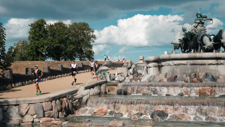 Runners pass the fountain at IRONMAN Copenhagen