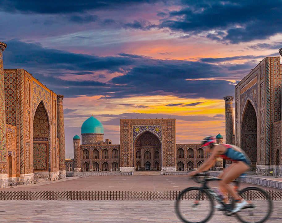 Cyclist passes stunning architecture at Challenge Samarkand