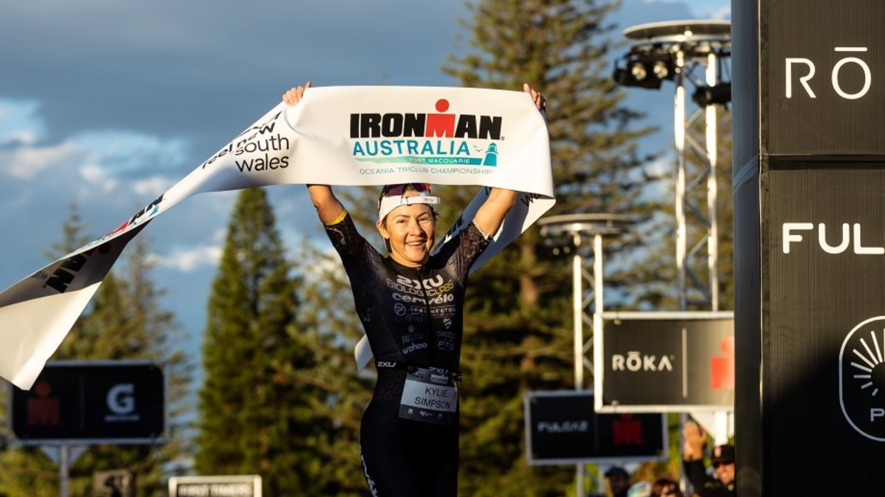 Kylie Simpson crossing the finish line at IRONMAN Australia [Photo credit: Korupt Vision]