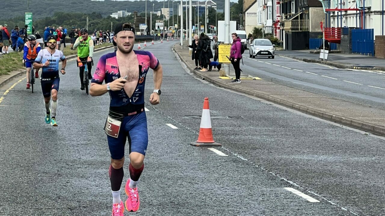 Andrew Horsfall-Turner about to be caught at IRONMAN 70.3 Swansea 2023