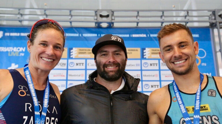 Joel Filliol with athletes Katie Zaferes and Belle Geens.