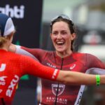 Taylor Knibb and Kat Matthews embrace on the finish line (Photo by Nigel Roddis, Getty Images for IRONMAN)