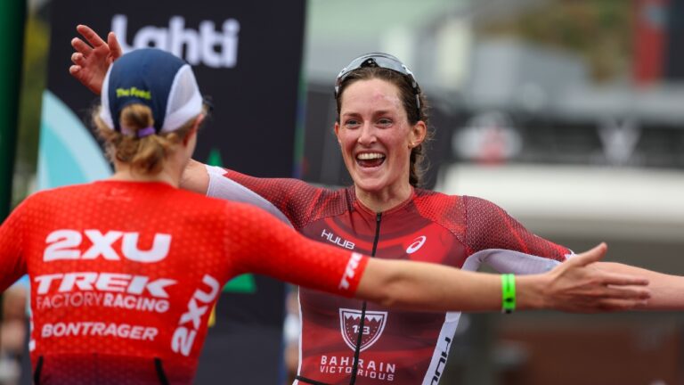 Taylor Knibb and Kat Matthews embrace on the finish line (Photo by Nigel Roddis, Getty Images for IRONMAN)