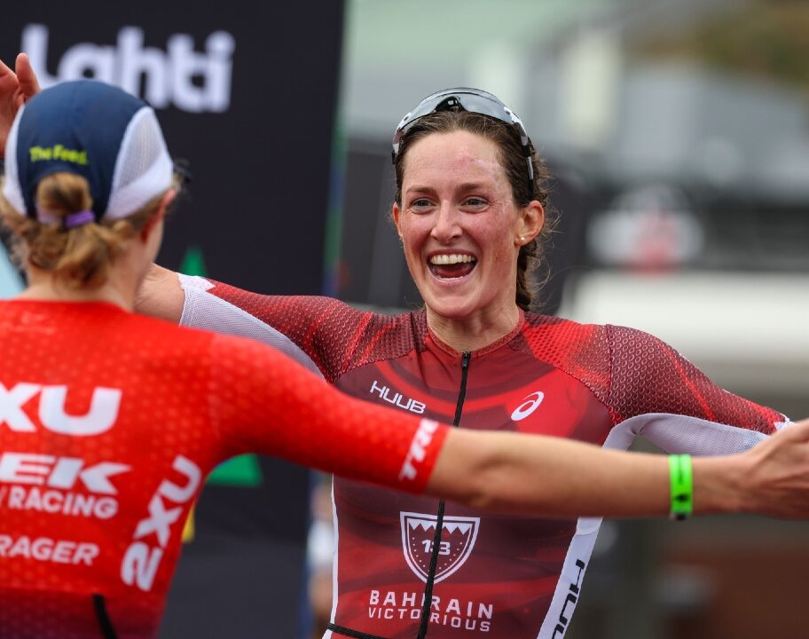 Taylor Knibb and Kat Matthews embrace on the finish line (Photo by Nigel Roddis, Getty Images for IRONMAN)