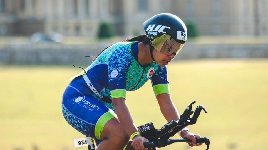 Female triathlete riding a time trial bike at Outlaw Half Holkham