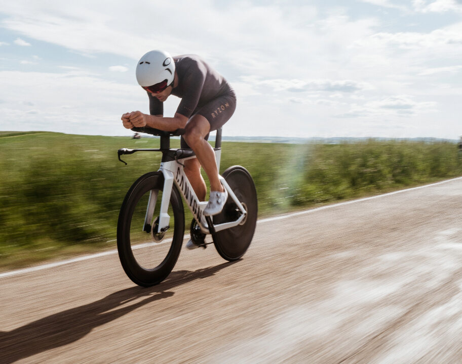 Triathlete riding a time trial bike wearing a Ryzon tri suit