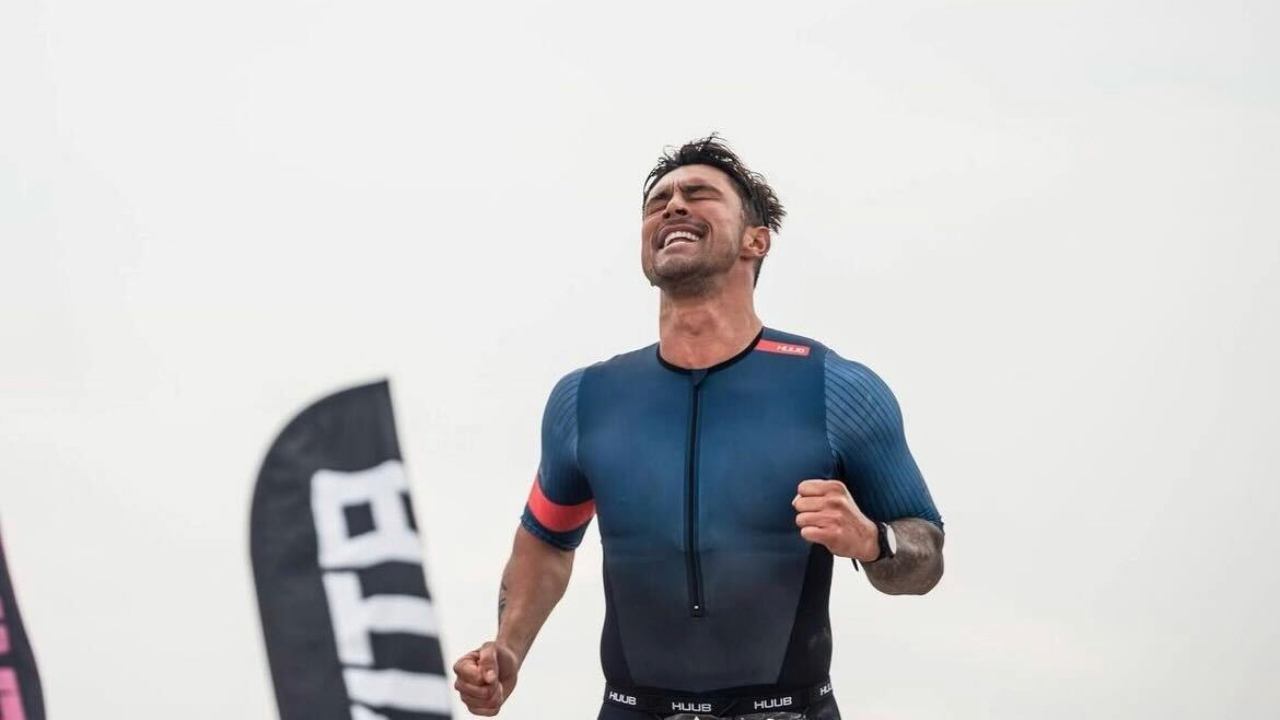 Bradley Howard crossing the finish line at The Roc triathlon