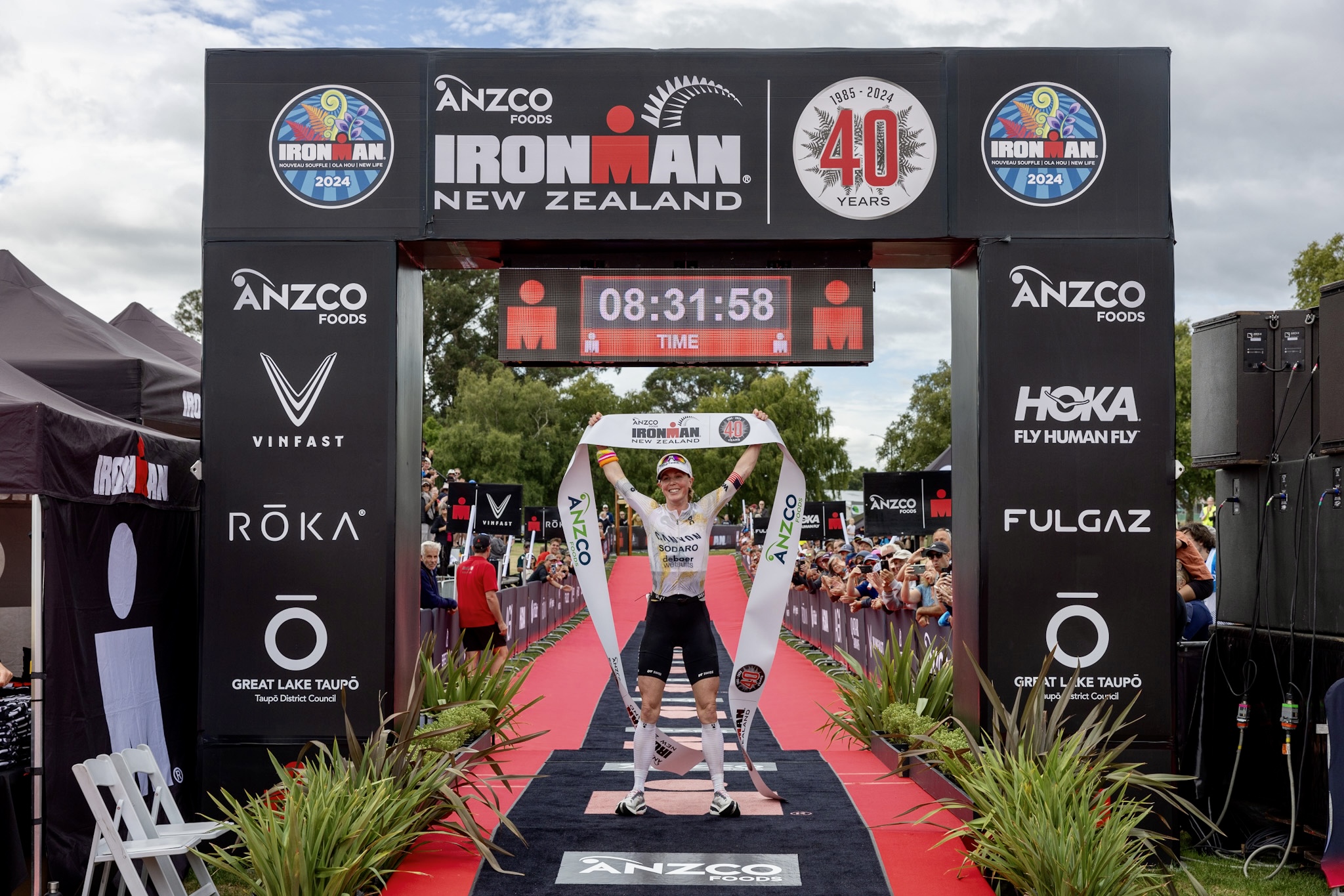 Chelsea Sodaro takes the tape at the 2024 IRONMAN New Zealand.