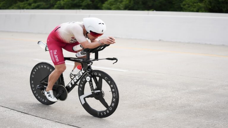 Triathlete wearing white and black trisuit rides black Trek Concept SLR with 1x drivetrain