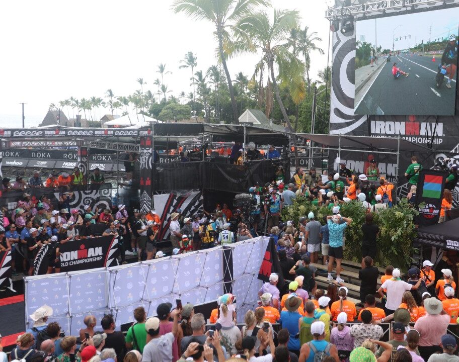 Taylor Knibb sat on road as crowd watch at finish of IRONMAN World Championship Kona 2025