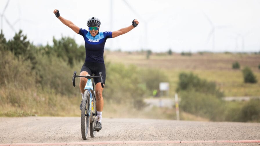 Caroline Livesey celebrates as she crosses the line to win the first Scottish National Gravel Championships. [Photo credit: Outsider events] 