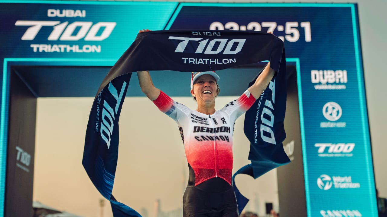 Swiss triathlete Julie Derron celebrates after winning the T100 World Tour event in Dubai 2025.