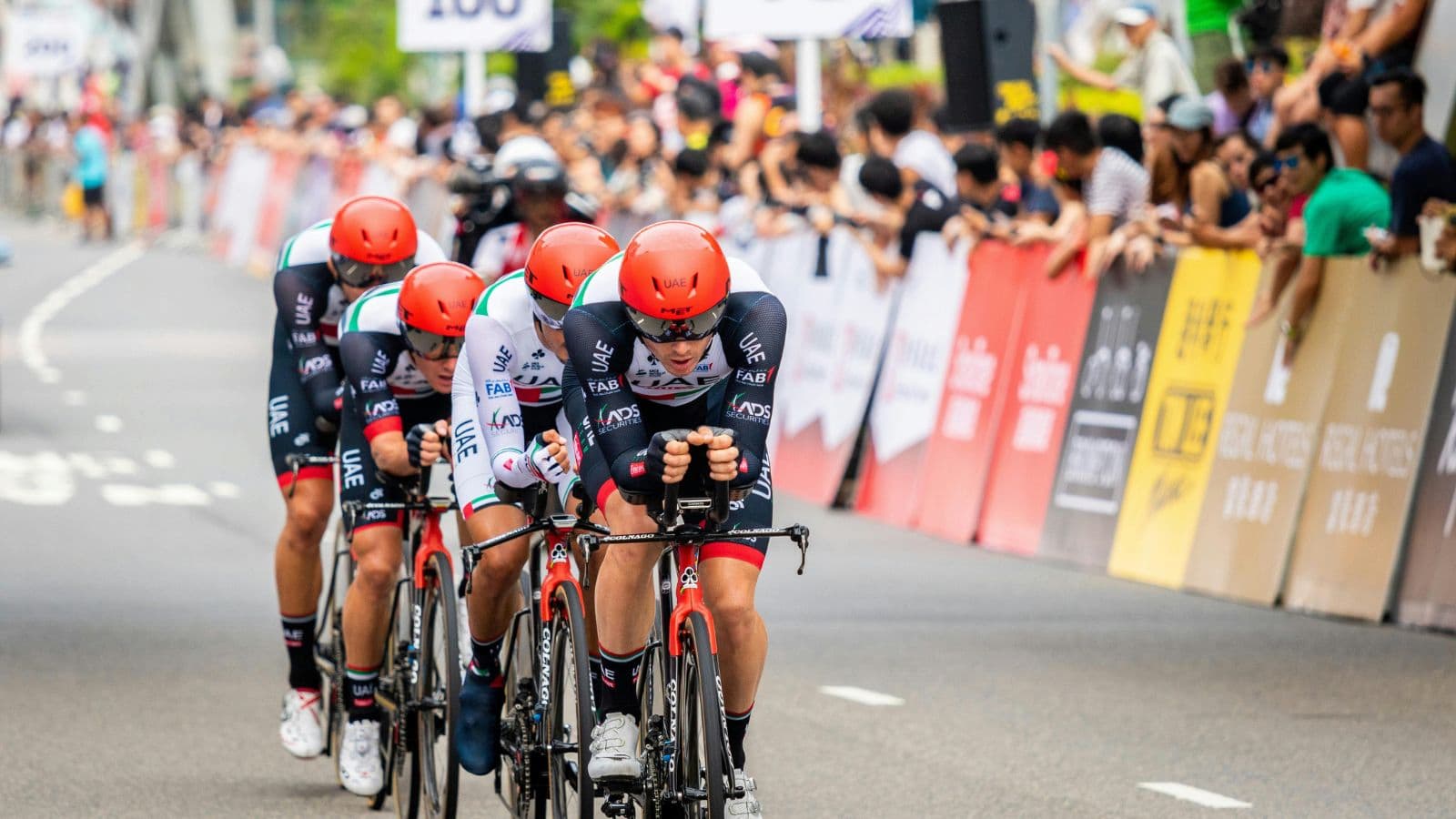Triathletes cycling during race, maintaining steady power and aerodynamic position on the bike