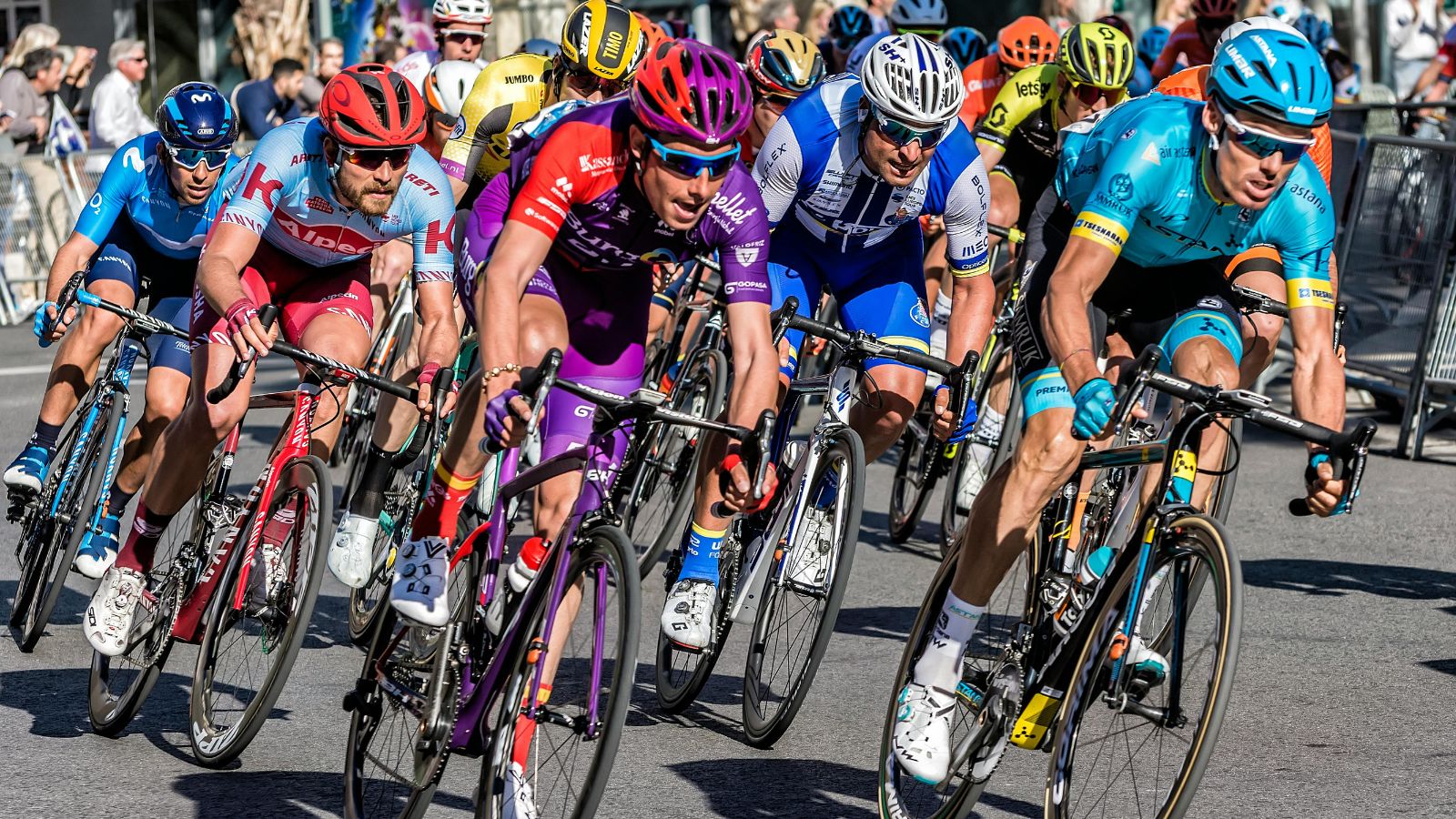 Group of cyclists racing on road bikes during a triathlon event, focusing on speed, endurance, and cycling performance training