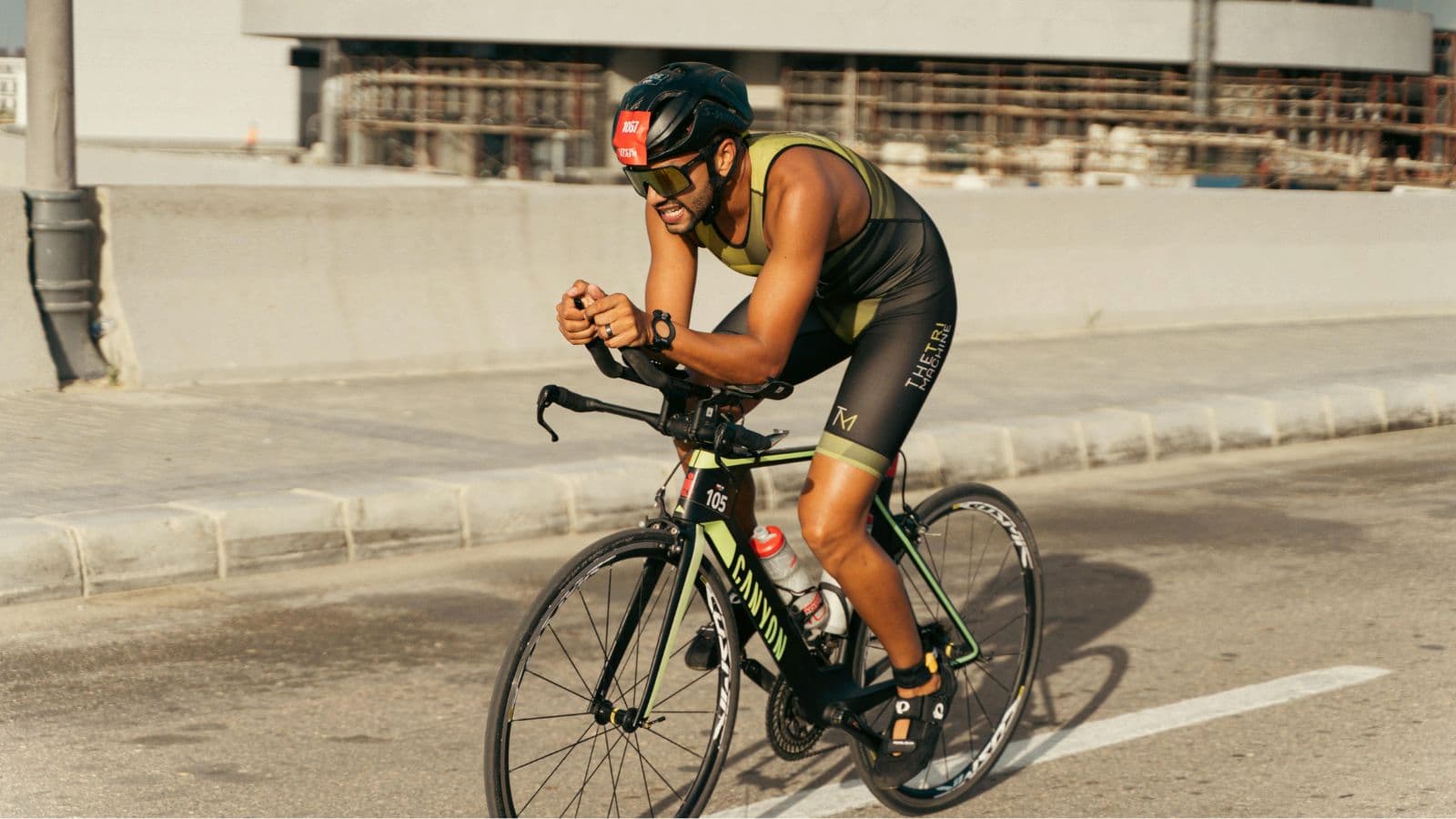 Triathlete riding in an aerodynamic position during the bike leg of a triathlon race