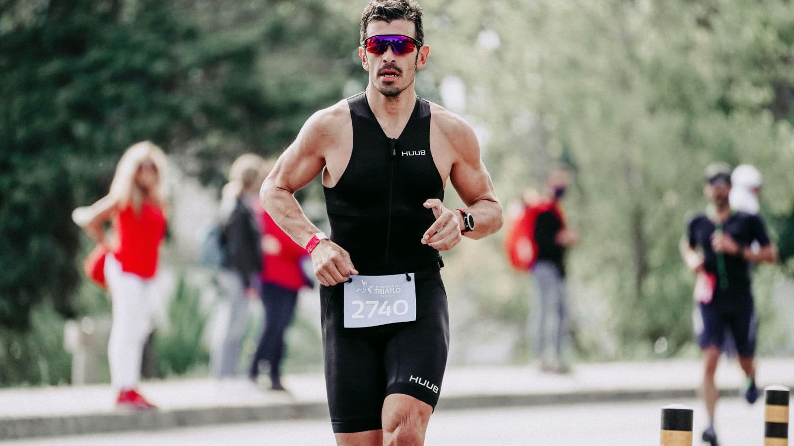 Triathlete racing at high intensity during competition, showing endurance, pacing, and race execution