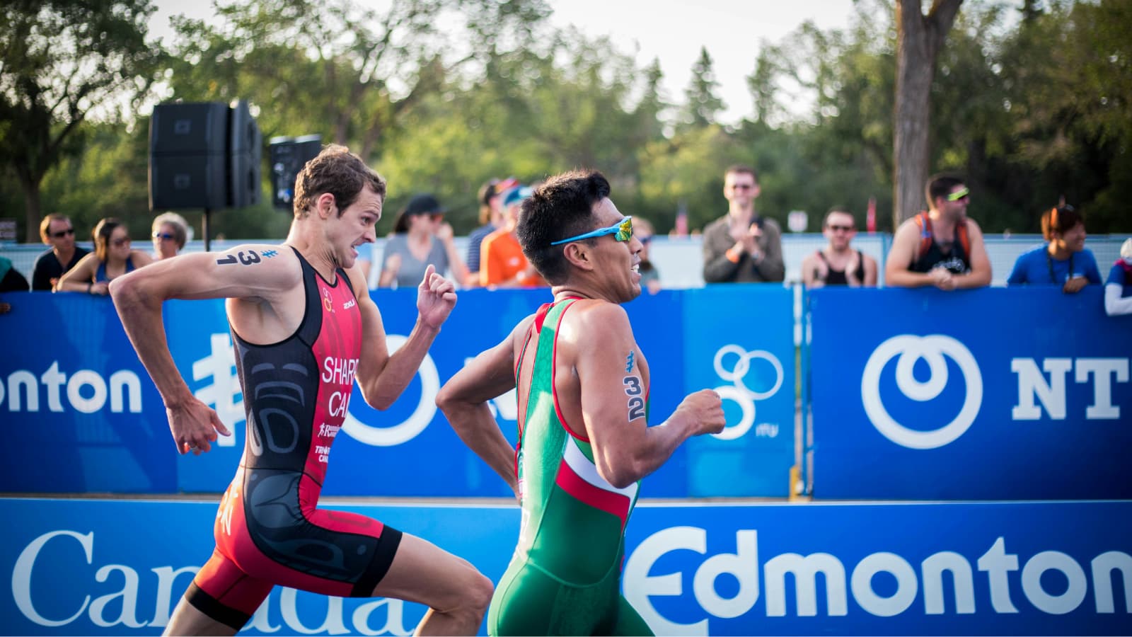 Triathletes running at controlled pace during race after tapering phase, showing fresh legs and efficient performance