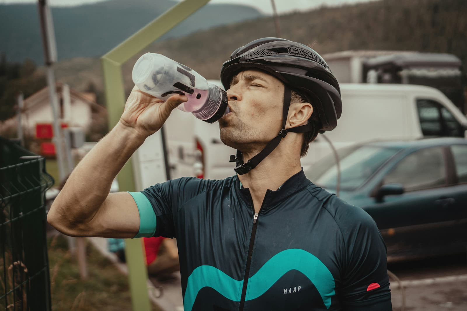 Cyclist drinking from bottle during ride to maintain energy levels