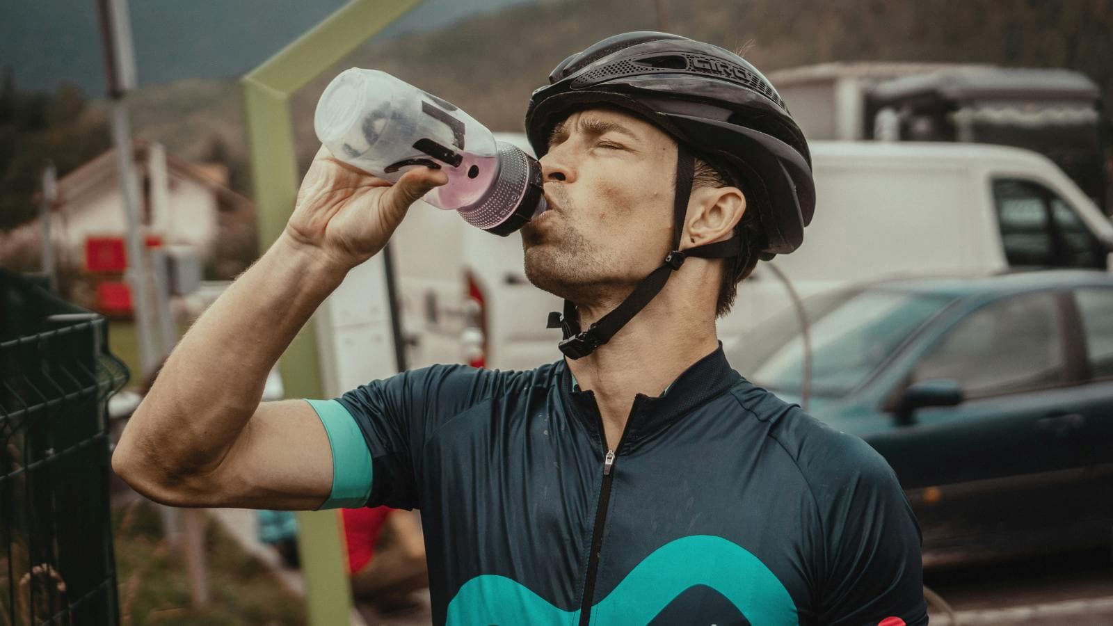 cyclist drinking water during bike ride to maintain hydration and endurance performance