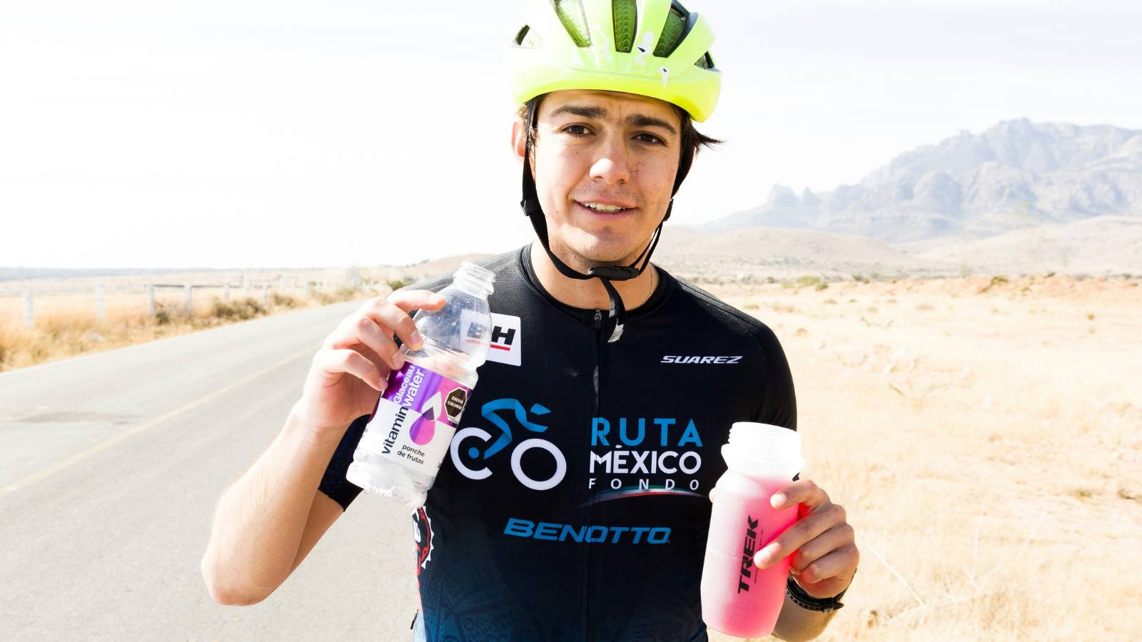 Triathlete drinking electrolyte solution during a race to stay hydrated and maintain energy